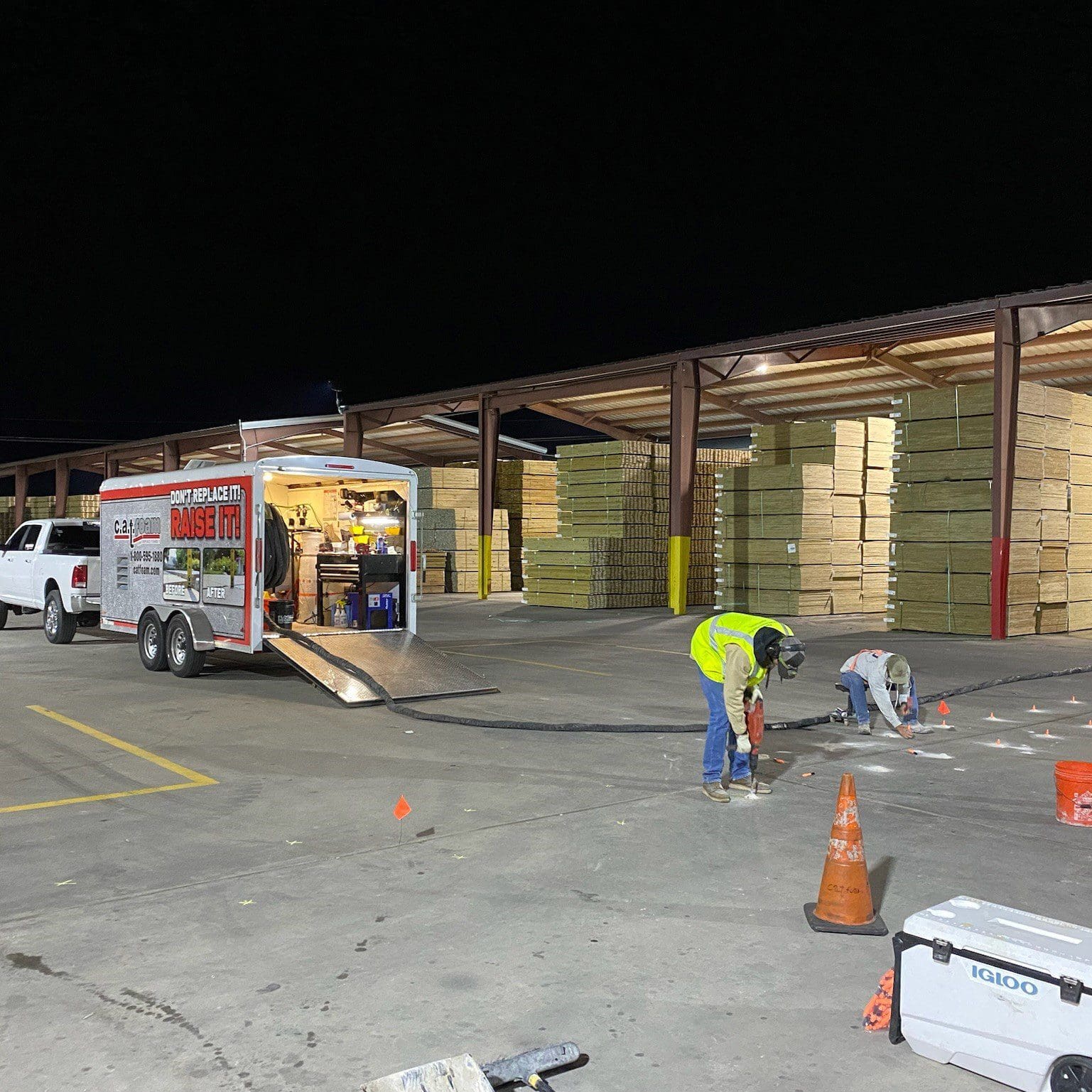 Workers at night in lumber yard.